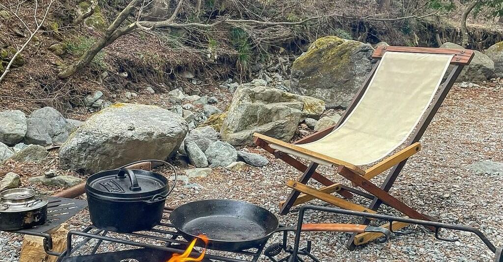 a campfire and a yellow folding chair