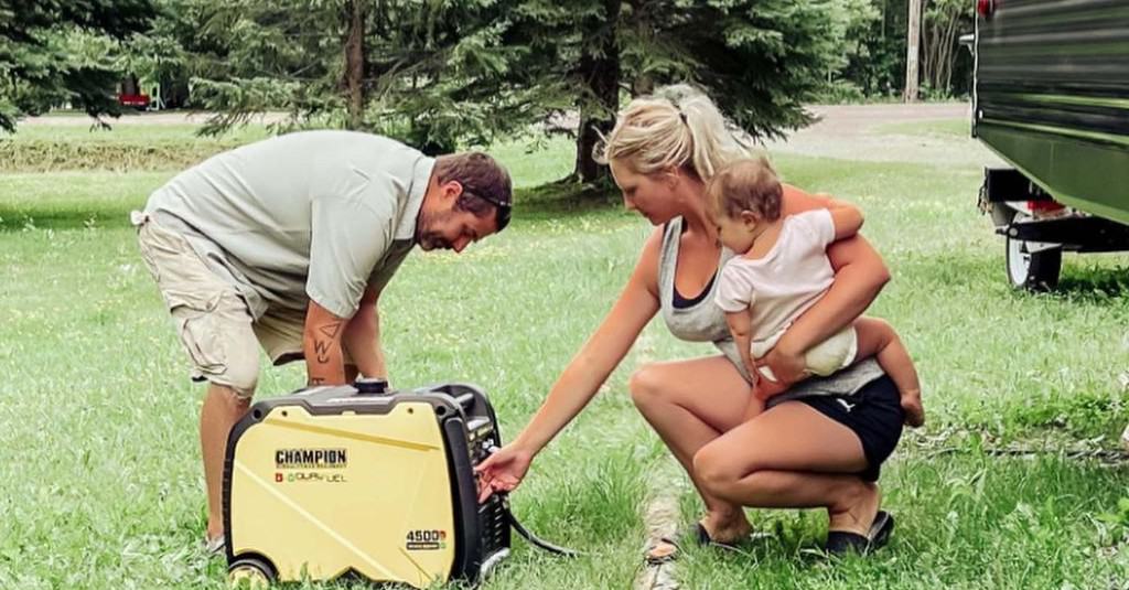 a man and a woman plugging in a generator
