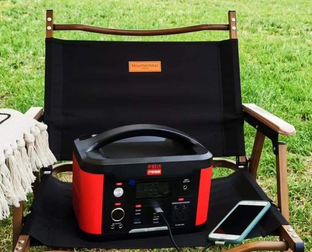 The portable generator on the chair charges your smartphone