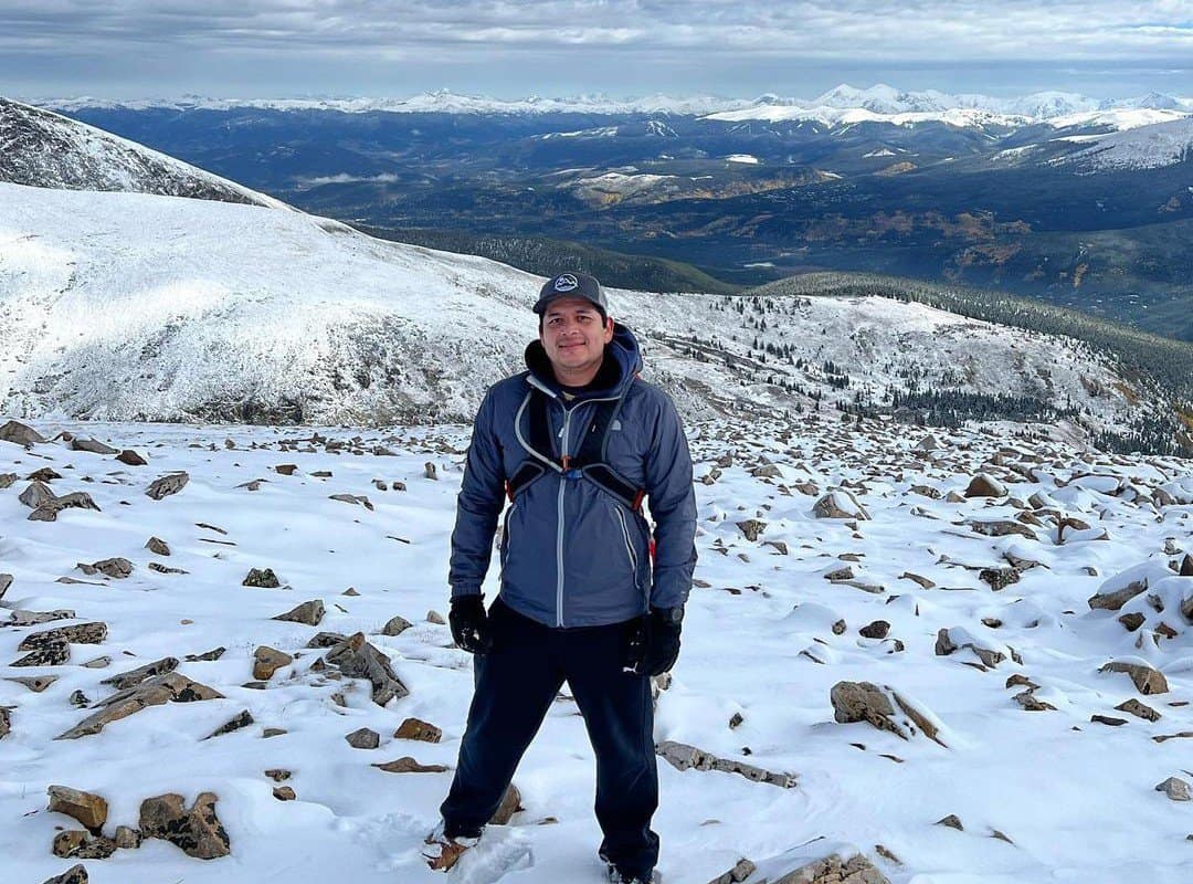 man hiker in winter gear in front of the Colorado