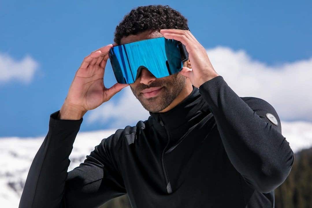 skier wears a ski mask with a blue lens